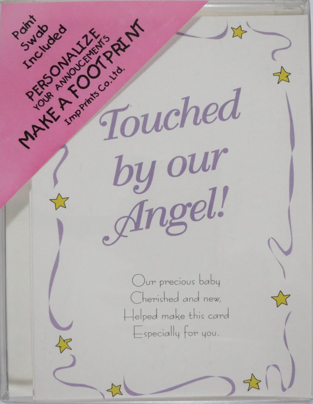 Picture of a plastic box containing Imp Prints Co Angel Footprint Birth Announcement Kit. Inside a whimsical purple border with yellow stars, it says "Touched by our Angel!" Underneath is a poem "Our precious baby, Cherished and new, Helped make this card, Especially for you.